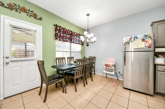 a dining room dining table chairs and a window