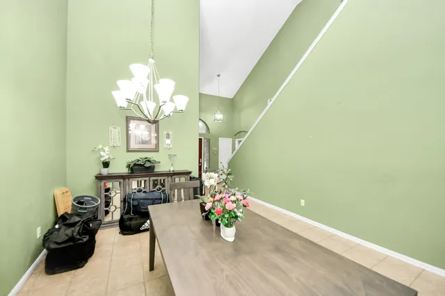 a view of a dining room with furniture and a chandelier