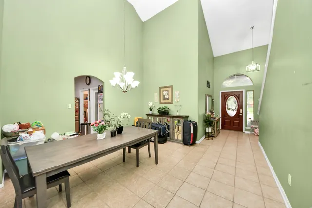 a view of a dining room with furniture and chandelier