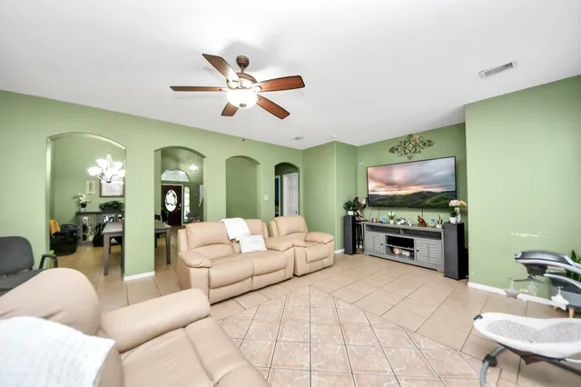a living room with furniture and a flat screen tv