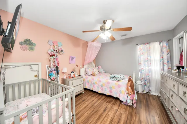 a bedroom with a bed and a large window