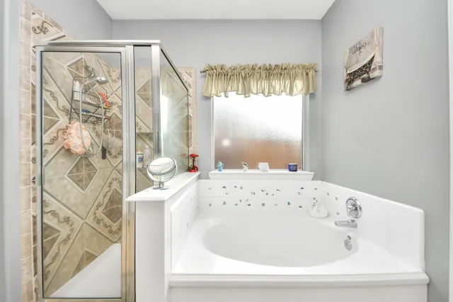 a bathroom with a bathtub and shower