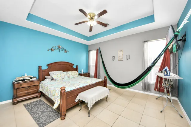 a bedroom with a bed and a chandelier