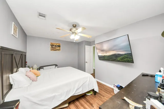 a bedroom with a bed and a chandelier