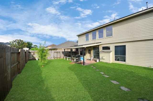 a view of a house with a yard and sitting area