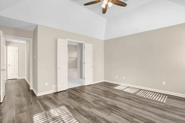 a view of a room with wooden floor