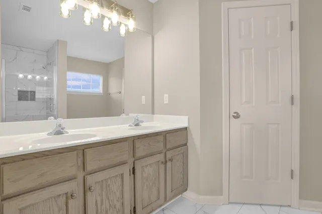 a bathroom with a double vanity sink a and a mirror