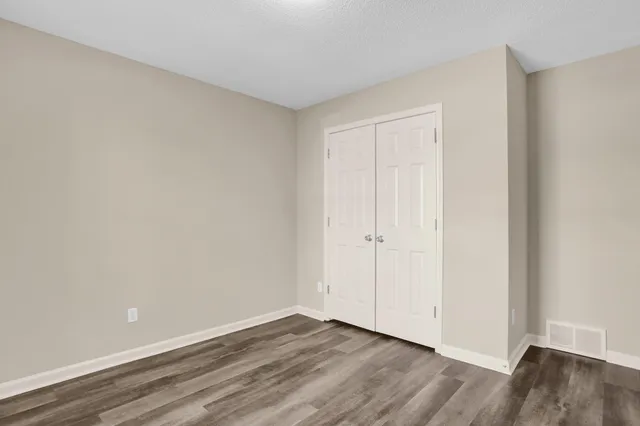 a view of an empty room and wooden floor