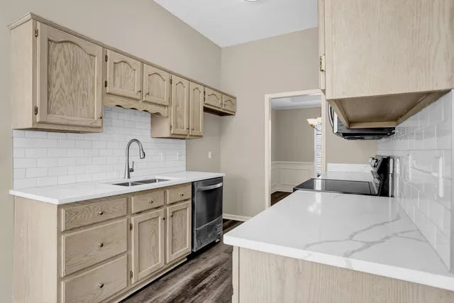 a kitchen with a sink and cabinets