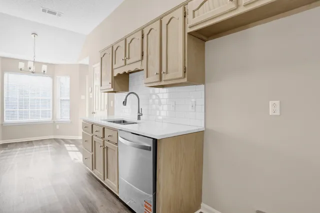a kitchen with stainless steel appliances granite countertop a sink stove and cabinets
