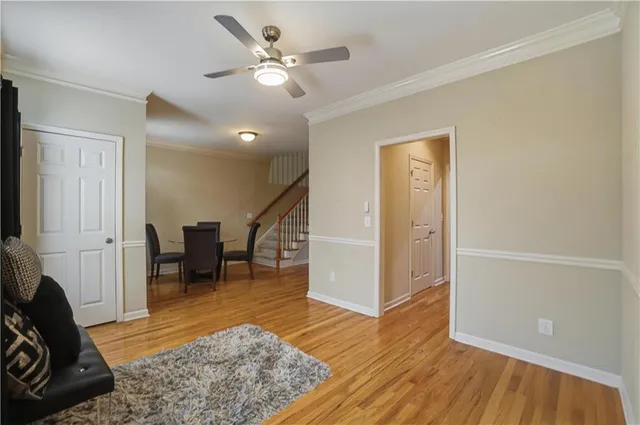 a view of a livingroom with furniture and a ceiling fan