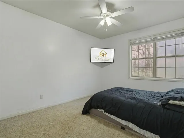 a bedroom with a bed and a window