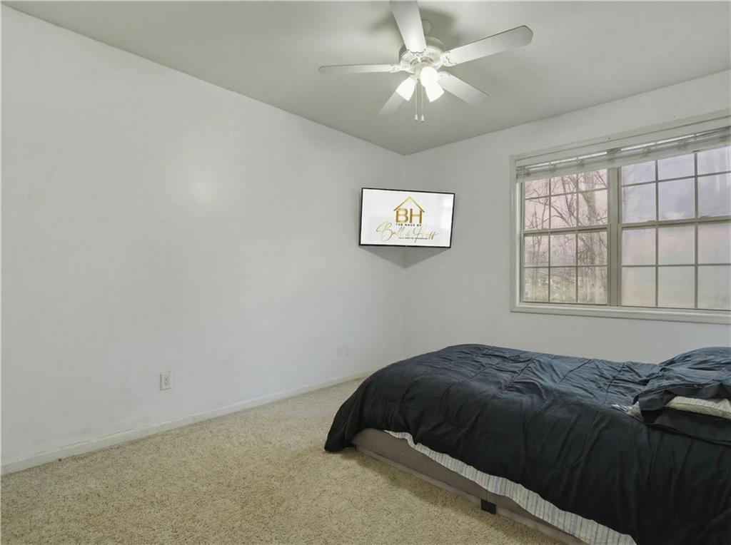 4414 George David Way Powder Springs, GA 30127 - Photo 16 of 29 a bedroom with a bed and a window