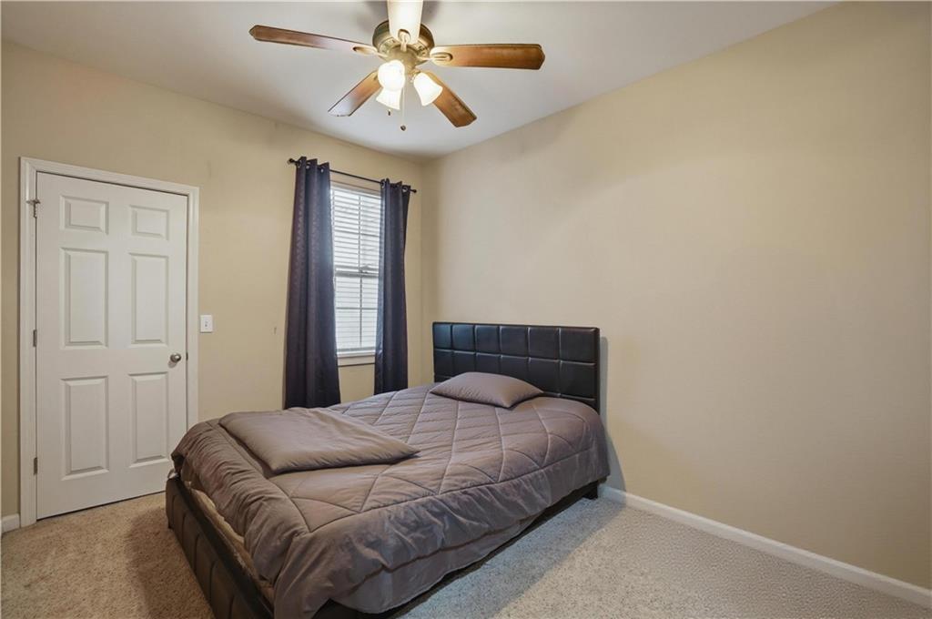 4414 George David Way Powder Springs, GA 30127 - Photo 17 of 29 a bedroom with a large bed and a chandelier