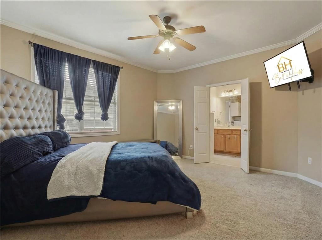 4414 George David Way Powder Springs, GA 30127 - Photo 21 of 29 a spacious bedroom with a bed and closet with wooden floor