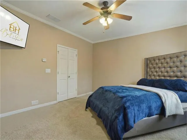 a bedroom with a bed and a painting on the wall