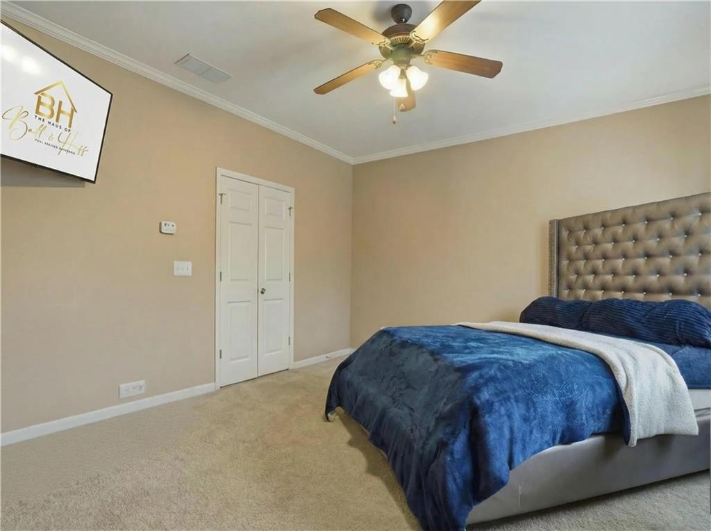 4414 George David Way Powder Springs, GA 30127 - Photo 22 of 29 a bedroom with a bed and a painting on the wall