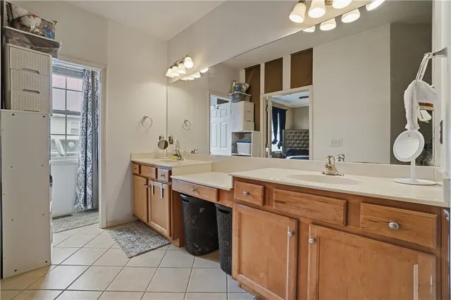 a bathroom with a granite countertop sink a large mirror and a shower