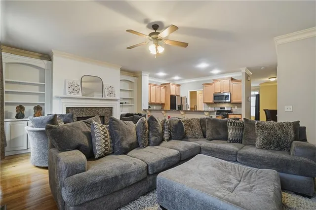 a living room with furniture and kitchen view