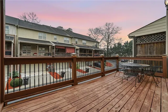 a balcony with wooden floors and bench