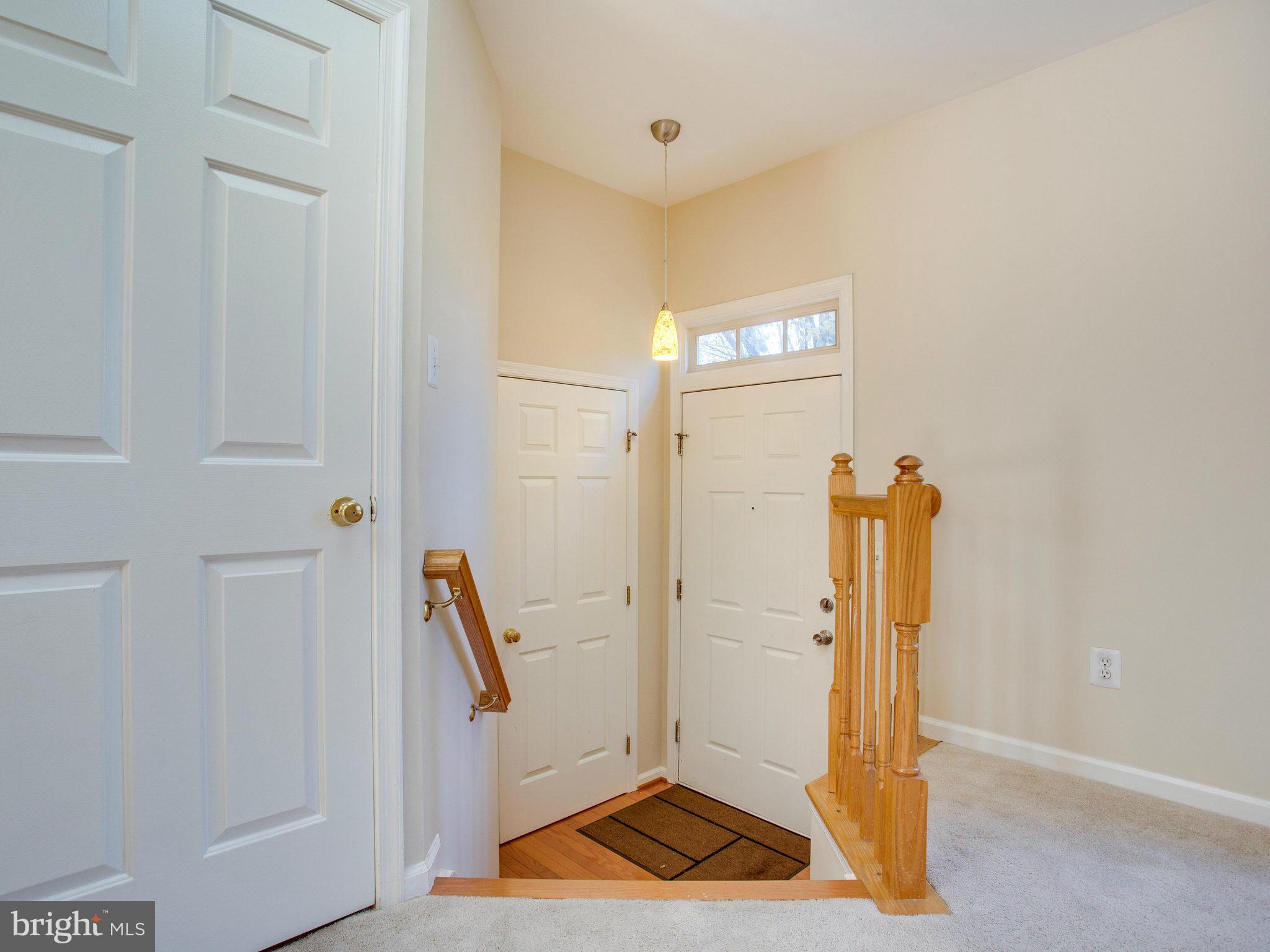 6395 Stagg Court Springfield, VA 22150 - Photo 2 of 30 a view of a hallway with paintings on the wall
