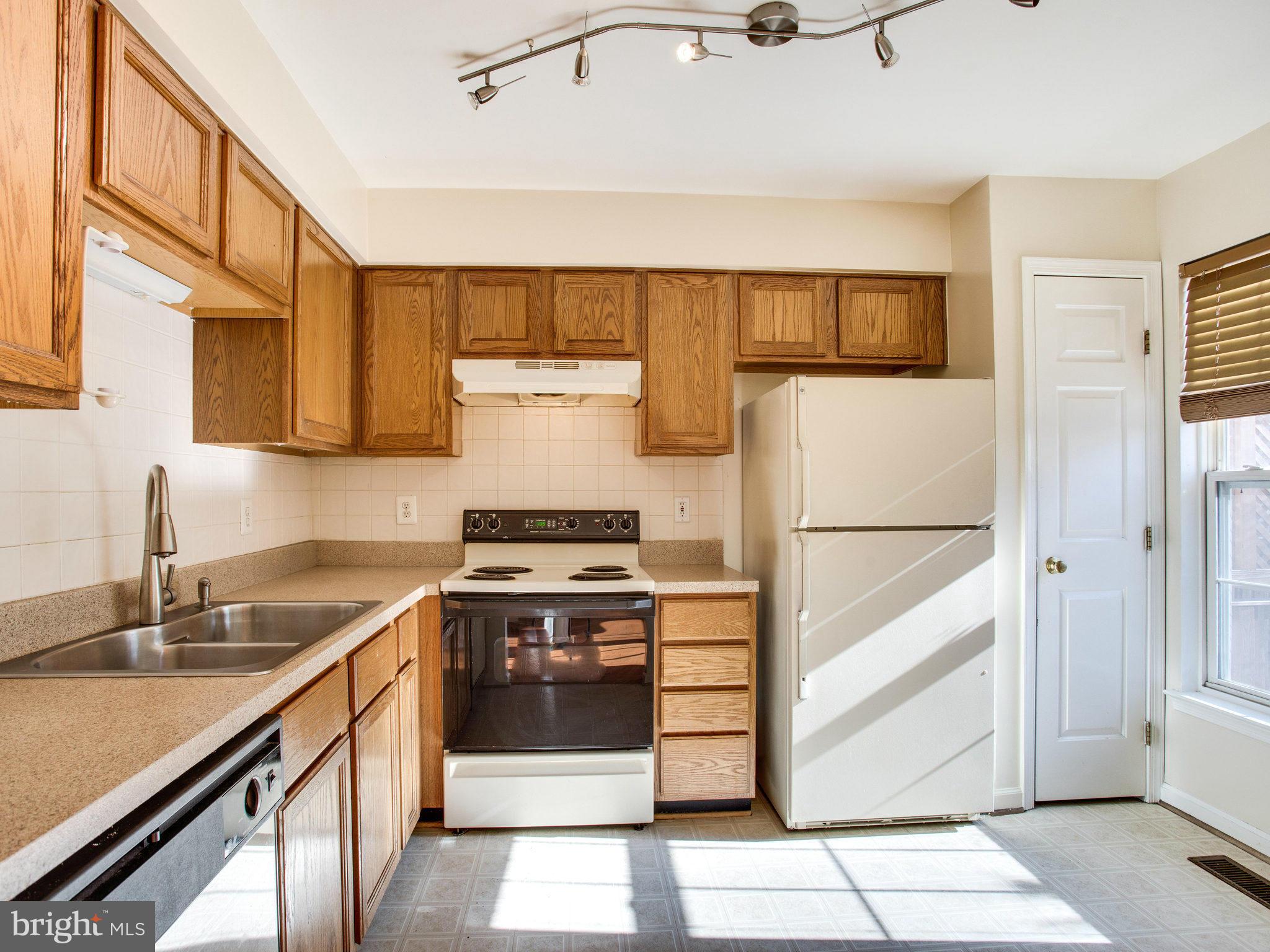 6395 Stagg Court Springfield, VA 22150 - Photo 9 of 30 a kitchen with a stove cabinets and a refrigerator