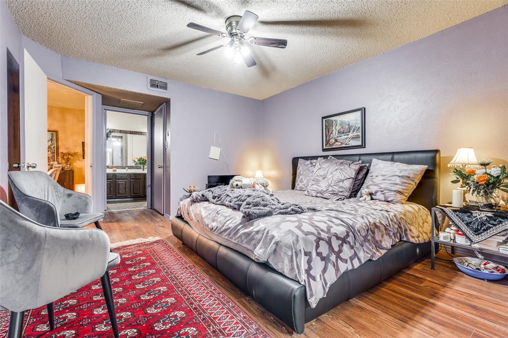 11470 Audelia Road, Unit 351 Dallas, TX 75243 - Photo 17 of 25 a spacious bedroom with a large bed and a chandelier