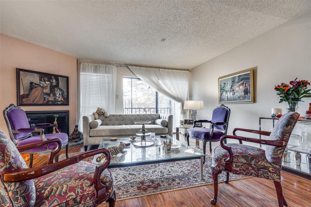 11470 Audelia Road, Unit 351 Dallas, TX 75243 - Photo 4 of 25 a living room with fireplace furniture and a large window