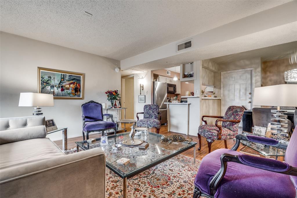 11470 Audelia Road, Unit 351 Dallas, TX 75243 - Photo 5 of 25 a living room with furniture a flat screen tv and kitchen view