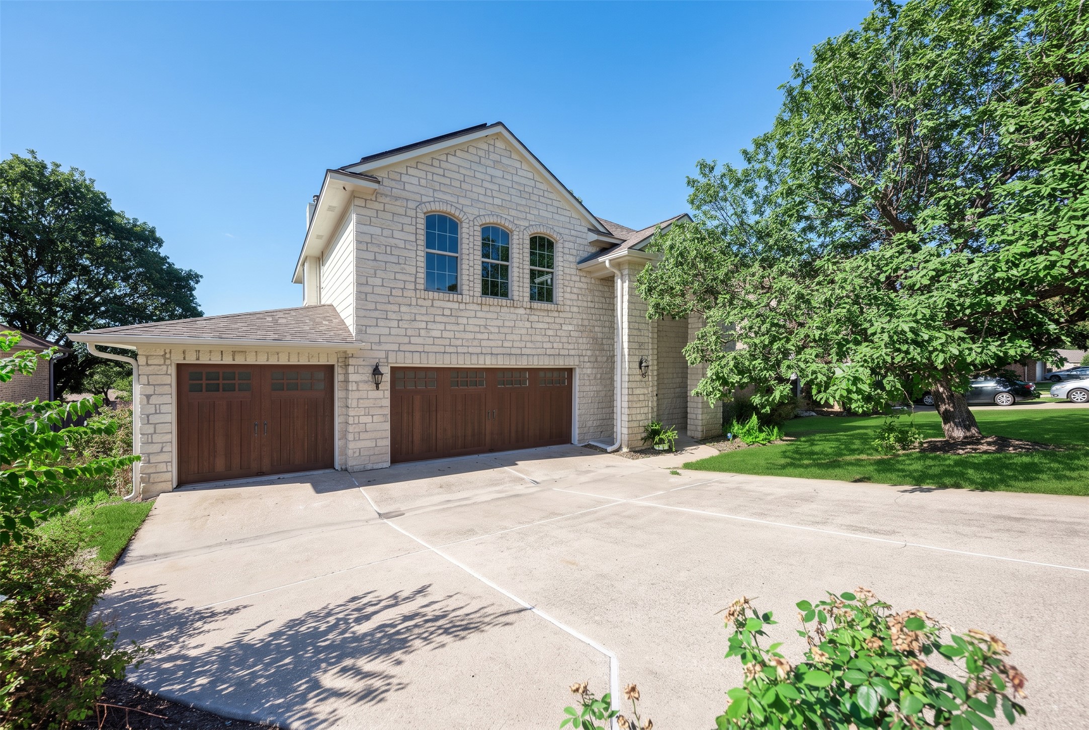 906 Antelope Ridge Cedar Park, TX 78613 - Photo 1 of 40 Arched windows and natural stone siding complement the wide concrete driveway leading to the garage.