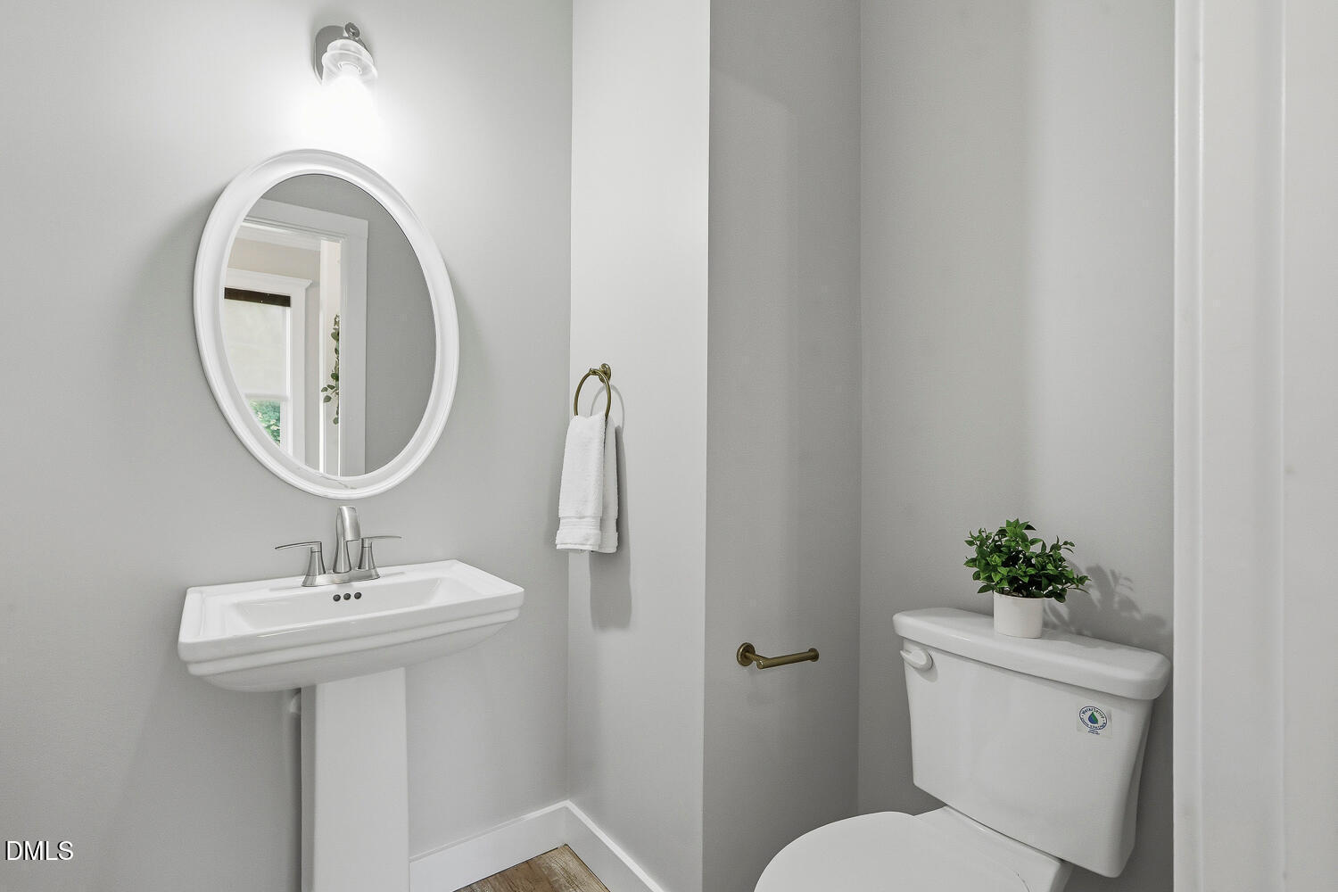 1605 Boyer Street Raleigh, NC 27610 - Photo 16 of 38 a bathroom with a toilet a sink and a mirror