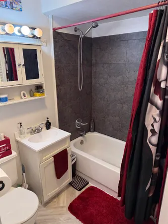 a bathroom with a sink a toilet and shower