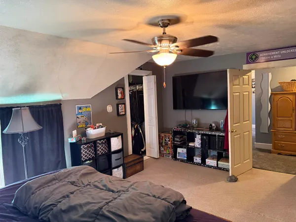 a bedroom with a bed and a chandelier