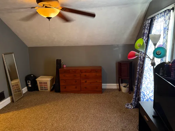 a bedroom with a bed and ceiling fan