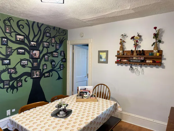 a dining room with furniture and wooden floor
