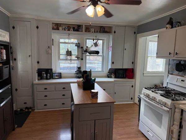 a kitchen with cabinets and window