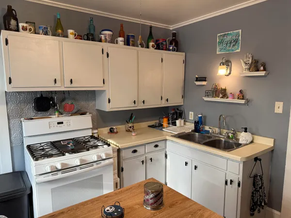 a kitchen with a sink stove and cabinets