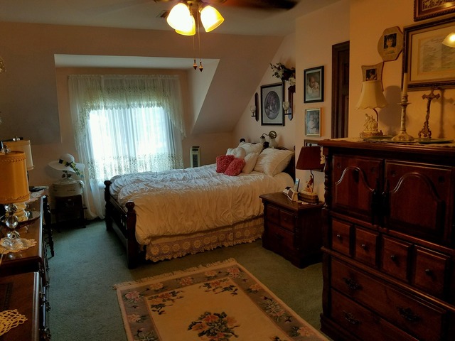 1619 Riverside Drive McHenry, IL 60050 - Photo 19 of 25 a bedroom with a bed and dresser with mirror