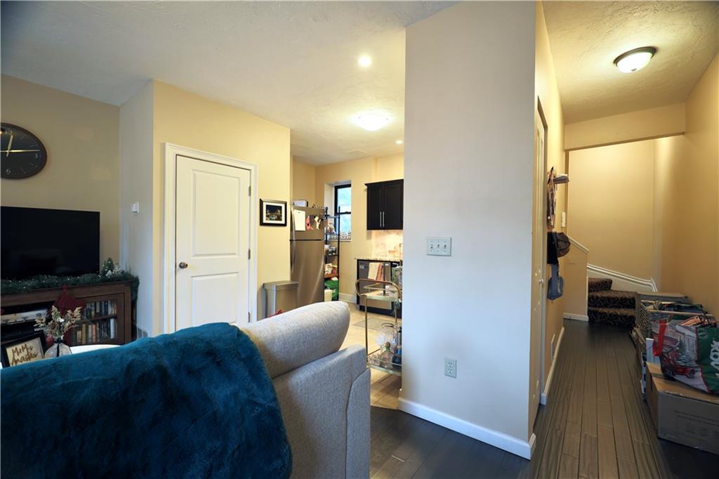 515 Lockhart Street, Unit 3 Pittsburgh, PA 15212 - Photo 15 of 27 a living room with furniture and a flat screen tv