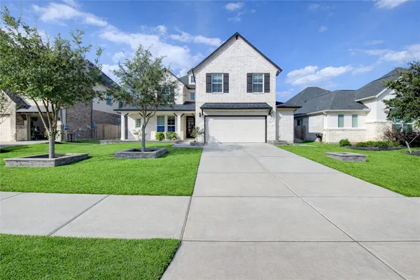 a view of a kitchen with white cabinets and wooden floor