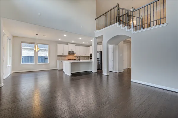 a view of a house with a yard and large tree