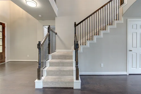 a kitchen with granite countertop a refrigerator sink and stove