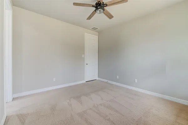 a large kitchen with stainless steel appliances a large counter top a stove a sink dishwasher and a refrigerator with wooden floor