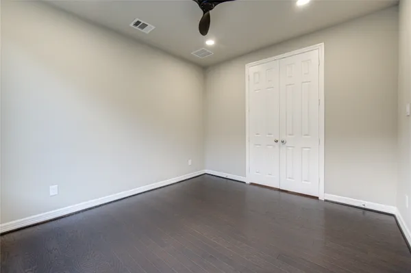 a view of an empty room and wooden floor