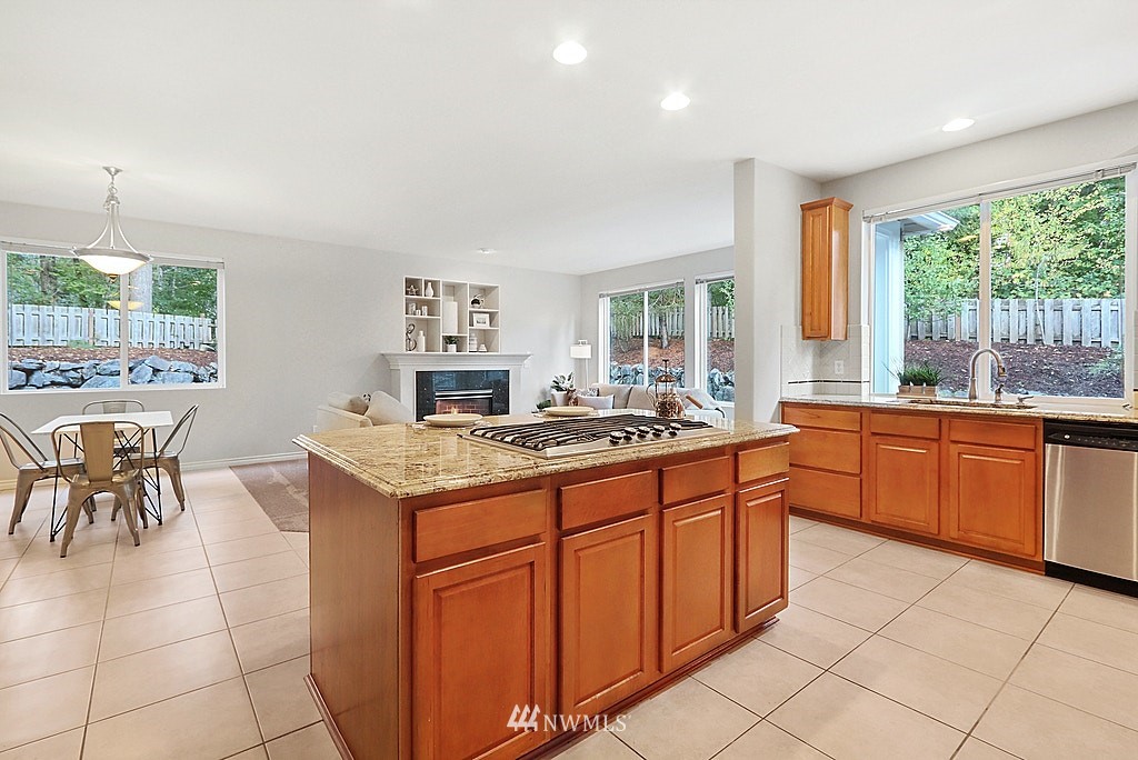 27714 Maple Ridge Way Southeast Maple Valley, WA 98038 - Photo 15 of 38 a kitchen with a sink stove and cabinets