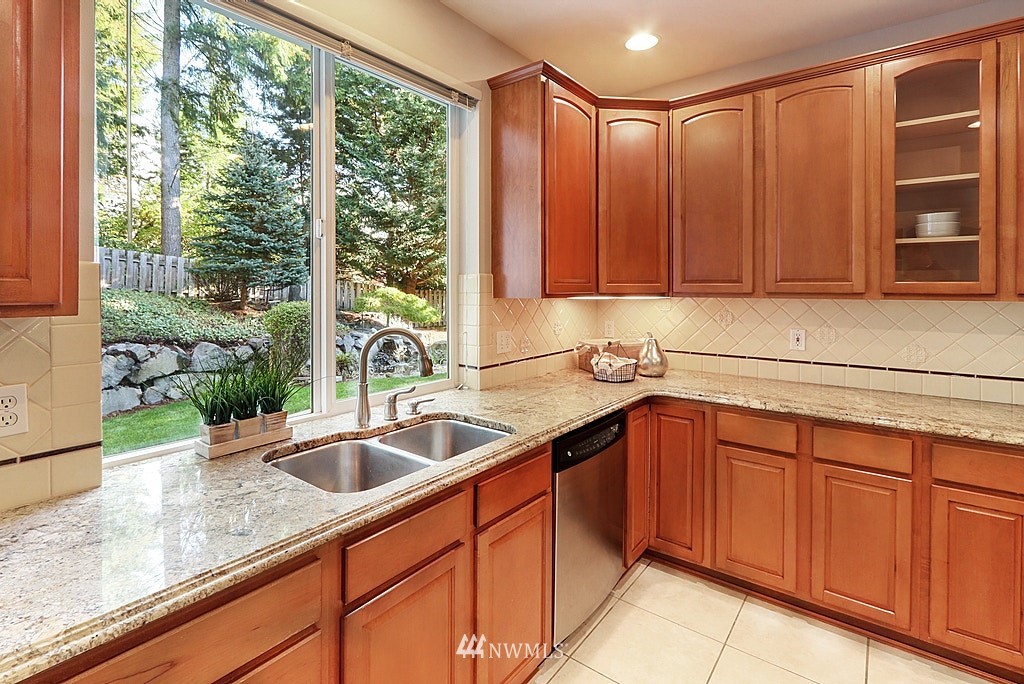 27714 Maple Ridge Way Southeast Maple Valley, WA 98038 - Photo 16 of 38 a kitchen with stainless steel appliances granite countertop a sink and a window
