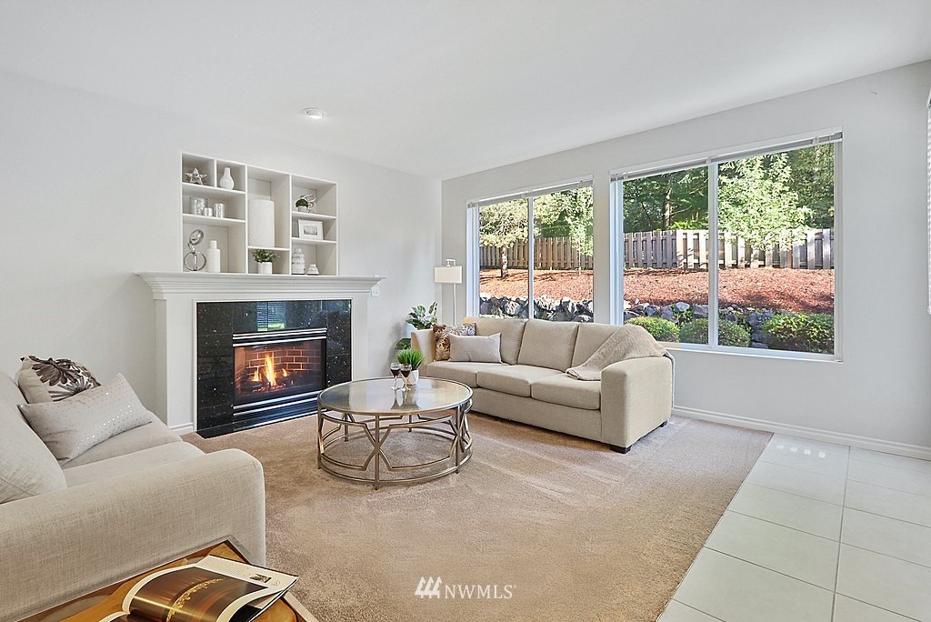 27714 Maple Ridge Way Southeast Maple Valley, WA 98038 - Photo 17 of 38 a living room with furniture and a fireplace