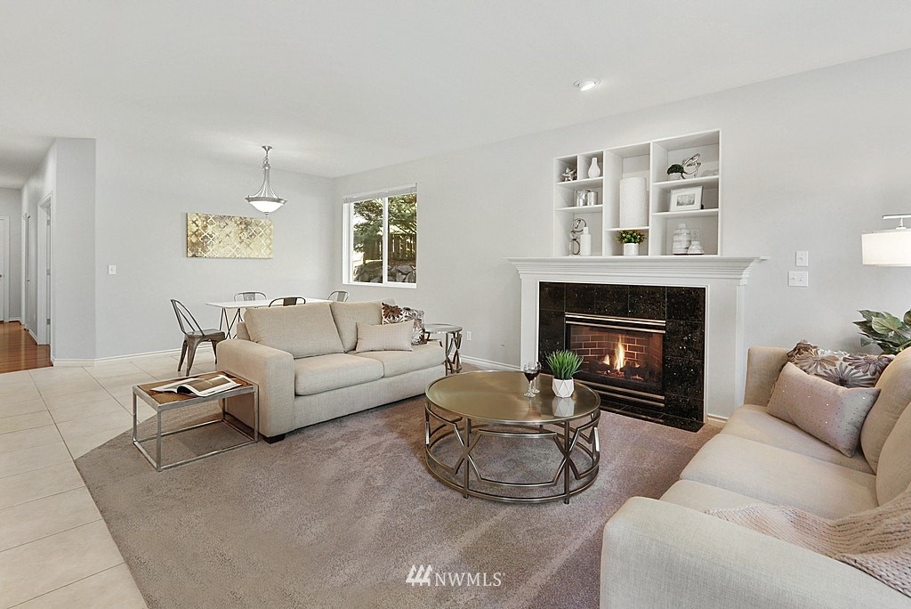 27714 Maple Ridge Way Southeast Maple Valley, WA 98038 - Photo 18 of 38 a living room with furniture and a fireplace