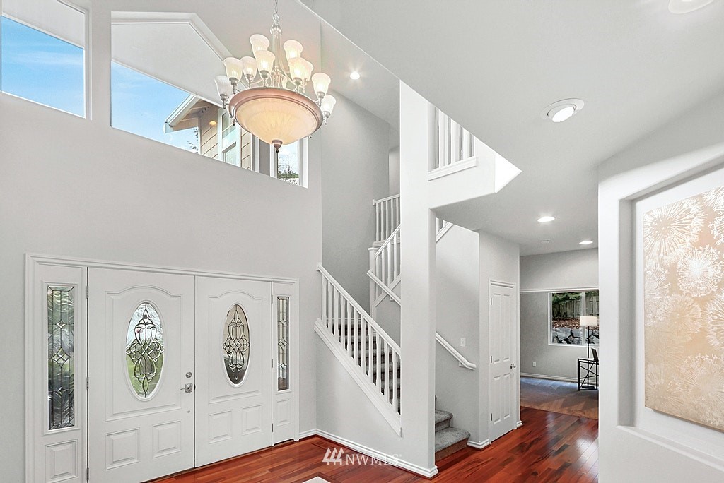 27714 Maple Ridge Way Southeast Maple Valley, WA 98038 - Photo 23 of 38 a view of a hallway with entryway wooden floor and front door