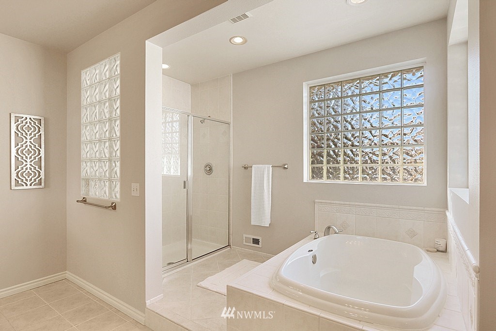 27714 Maple Ridge Way Southeast Maple Valley, WA 98038 - Photo 30 of 38 a bathroom with a bathtub and shower